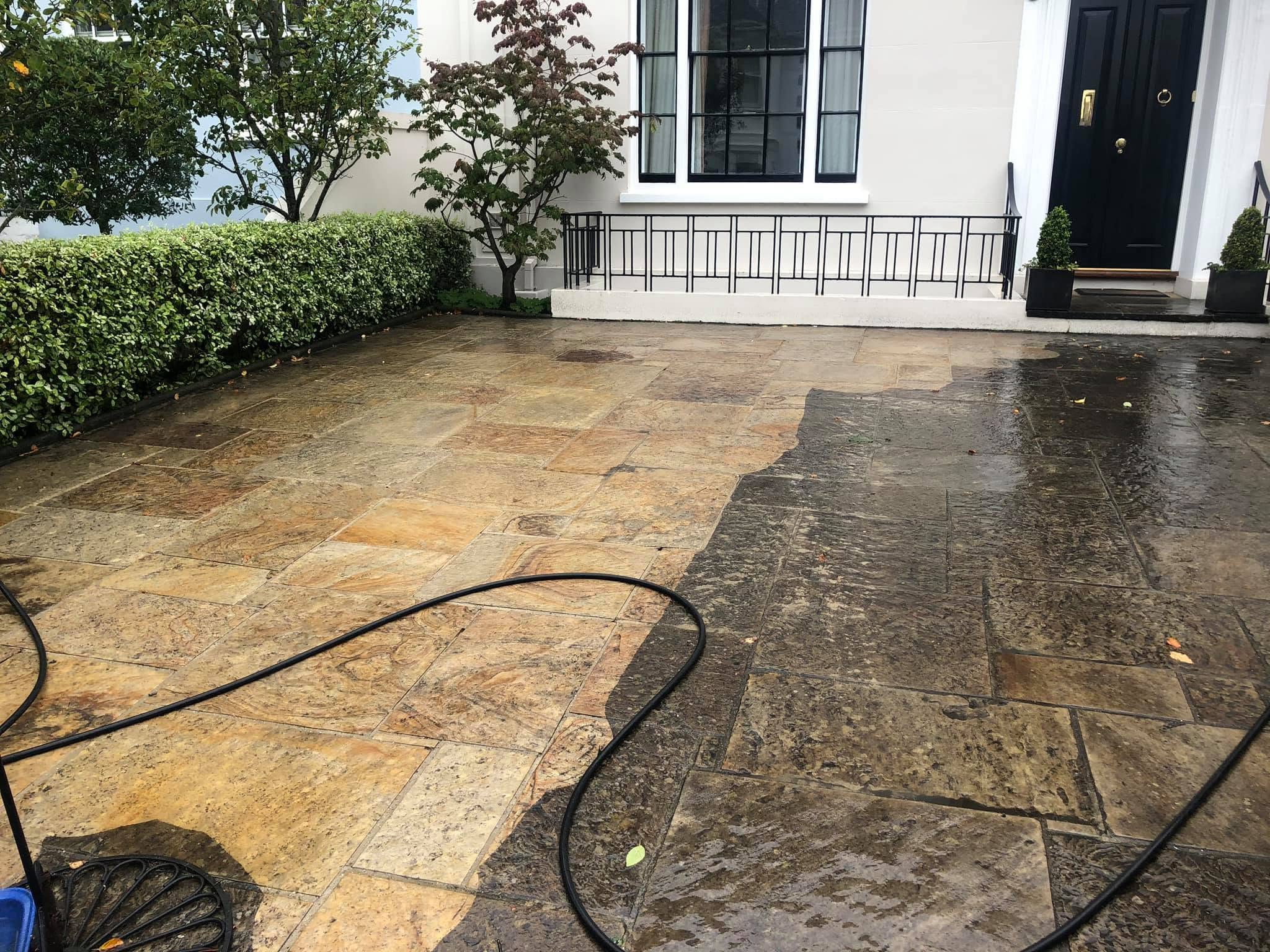 Pressure washer blasting dirt from a hard surface
